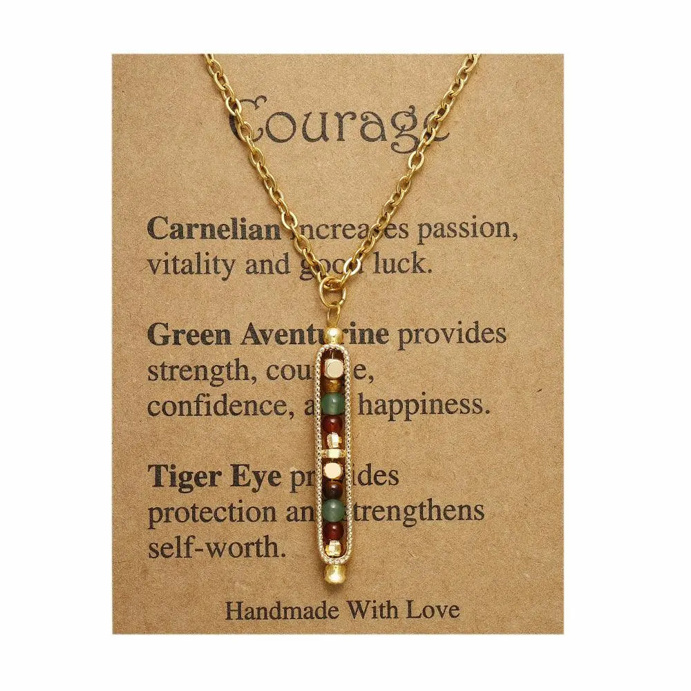 Gold courage pendant necklace with carnelian, green aventurine, and tiger eye on a handmade card.