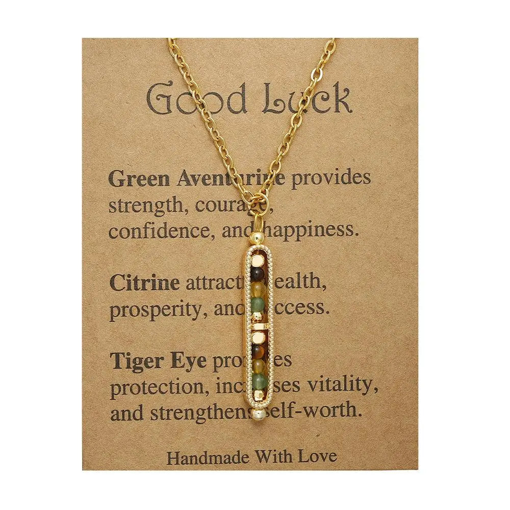 Light luxury gold pendant necklace with green aventurine, citrine, and tiger eye on a card about good luck.