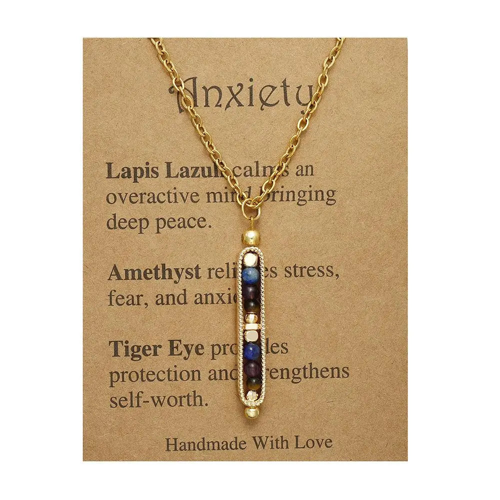 Gold necklace with lapis lazuli, amethyst, and tiger eye beads on a descriptive card about anxiety management.