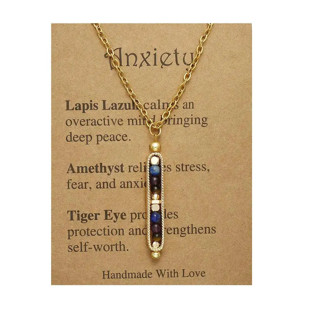Gold necklace with lapis lazuli, amethyst, and tiger eye beads on a descriptive card about anxiety management.