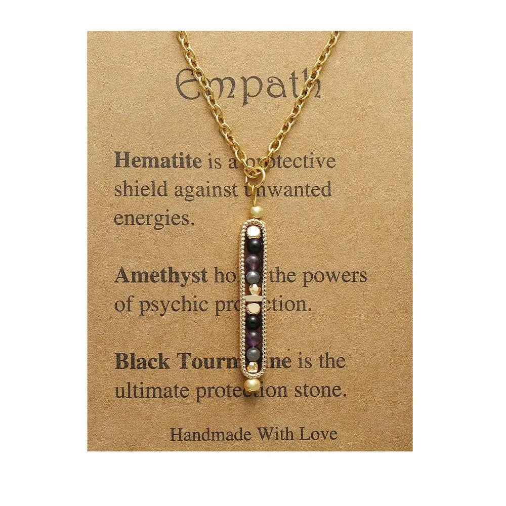 Light luxury pendant necklace with hematite, amethyst, and black tourmaline on a kraft paper card.