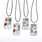 Four Seven-Color Gravel Rectangular Tree of Life Pendants on leather cords, showcasing vibrant crushed stones and wire craftsmanship.